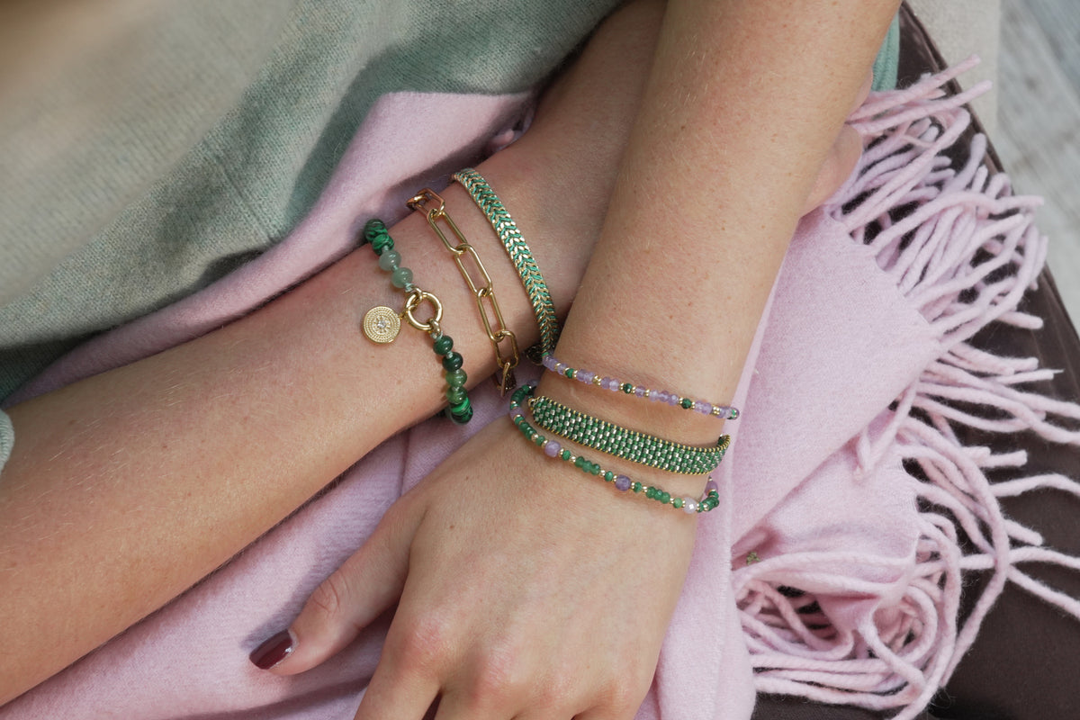 Fritta green and gold friendship bracelet by Boho Betty – styled in a stack, a gold green beaded braided thread bracelet