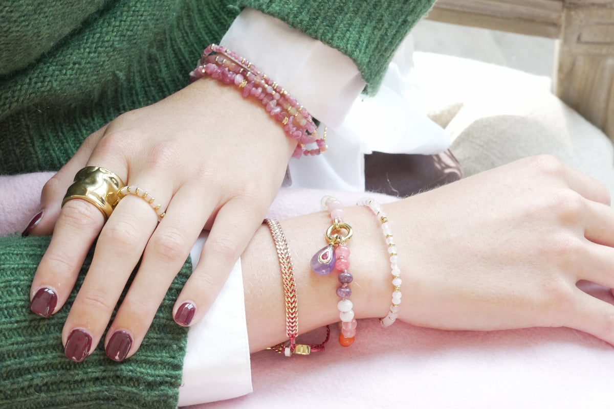 Mala rose quartz gold ring by Boho Betty – styled with other jewellery, a gold rose quartz beaded stretch ring