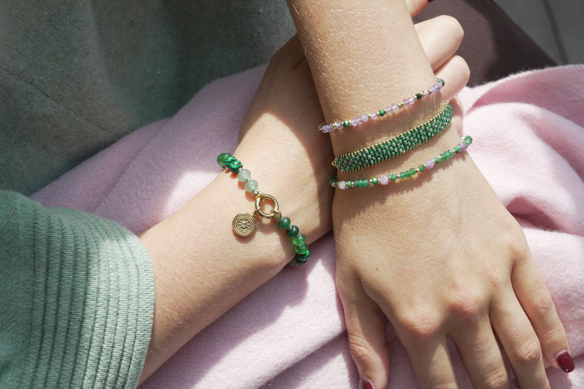 Meli gold, green and purple bead bracelet by Boho Betty – styled in a stack, a gold green and purple beaded stretch bracelet
