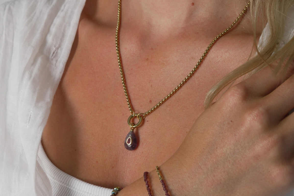 Thalia Fleurette amethyst gold teardrop pendant necklace by Boho Betty – layered with other jewellery, on a short gold chain