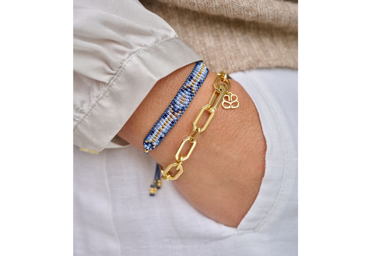 Lifestyle shot with stylish bracelet layering of Boho Betty Fantasy blue beaded friendship bracelet as the perfect stacking bracelet with Crisos Chain Bracelet. Effortless styling and the perfect gift for her.