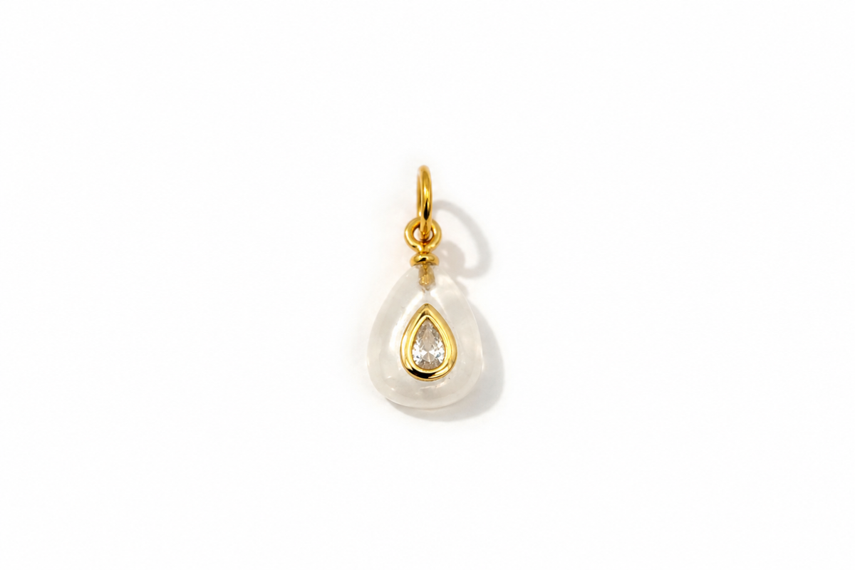 Fleurette Clear Quartz Charm Gold featuring a carved clear quartz gemstone with a sparkling crystal on a waterproof 14k gold PVD loop.