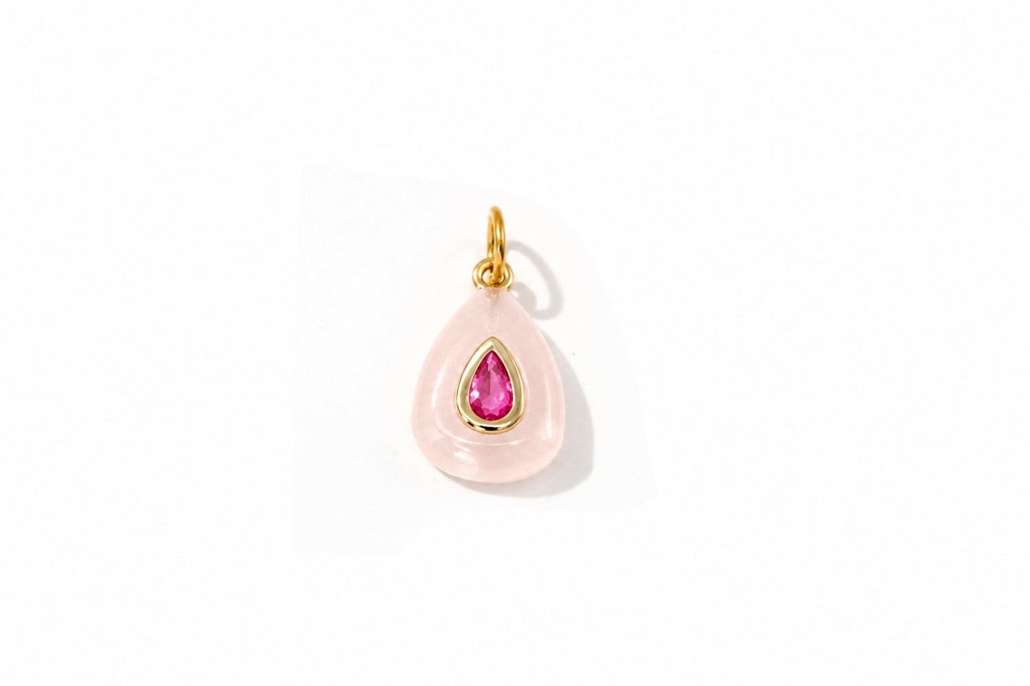 Fleurette Rose Quartz Charm Gold featuring a carved rose quartz gemstone with a ruby-coloured crystal on a waterproof 14k gold PVD loop.