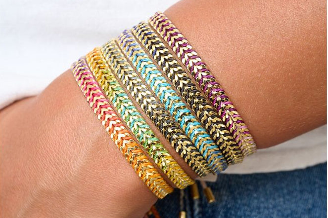 Iztac Blue & Gold Ombre Braided Bracelet styled on the wrist, showcasing ombre purple threads and shimmering gold chevron details.