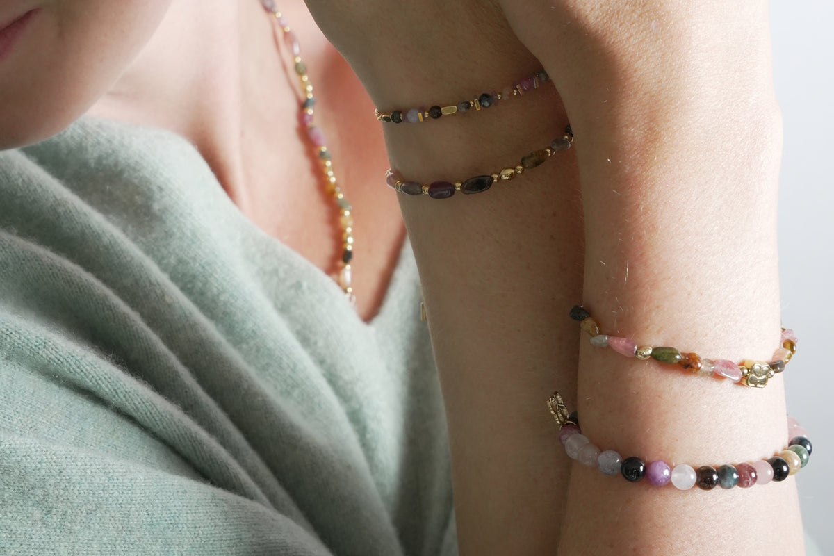 Charlene gold tourmaline gemstone bracelet by Boho Betty – styled in a stack, a gold tourmaline beaded stretch bracelet