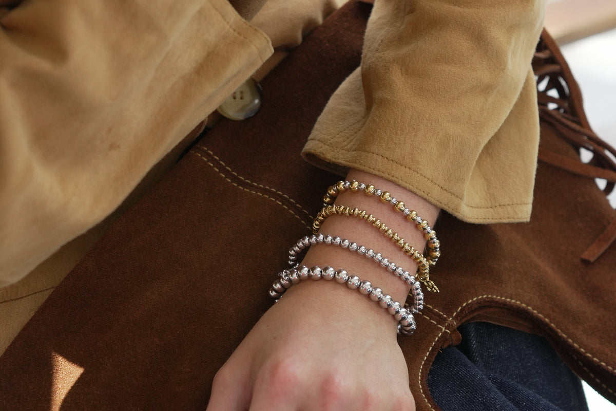 Gemma gold mixed metal bead bracelet by Boho Betty – styled in a stack, a stackable mixed metal beaded stretch bracelet