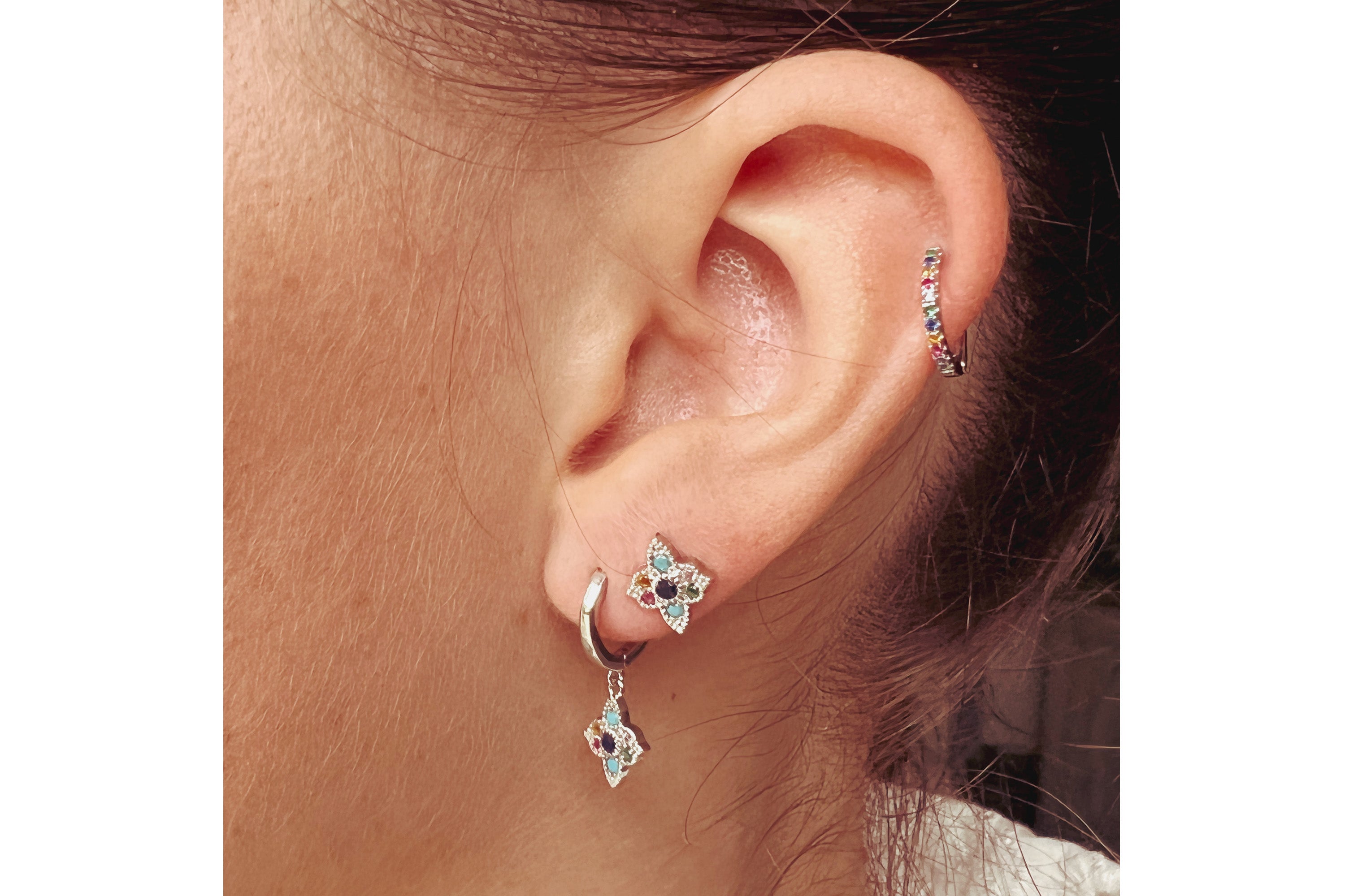 A lifestyle picture showcasing perfect earrings stacking of Boho Betty multi coloured CZ, Theron, Taki and dorval Sterling Silver Earrings