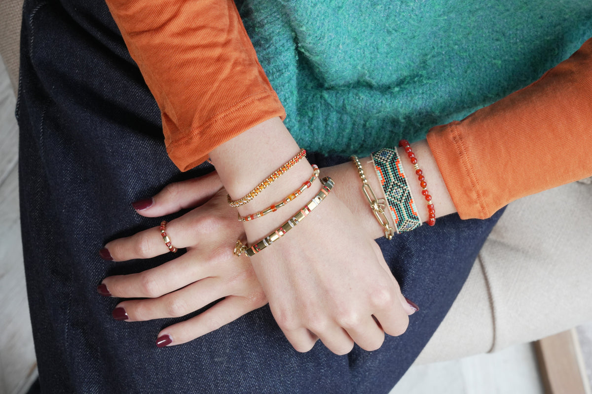 Zoom orange and gold tila bracelet by Boho Betty – styled in a stack, a stackable gold tila bead stretch bracelet