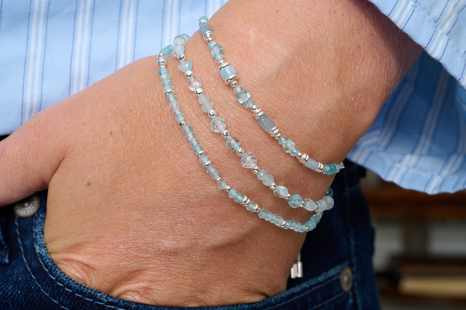 Altamura bracelet trio styled with denim, pale blue topaz and silver for a cool, serene day-to-night glow.