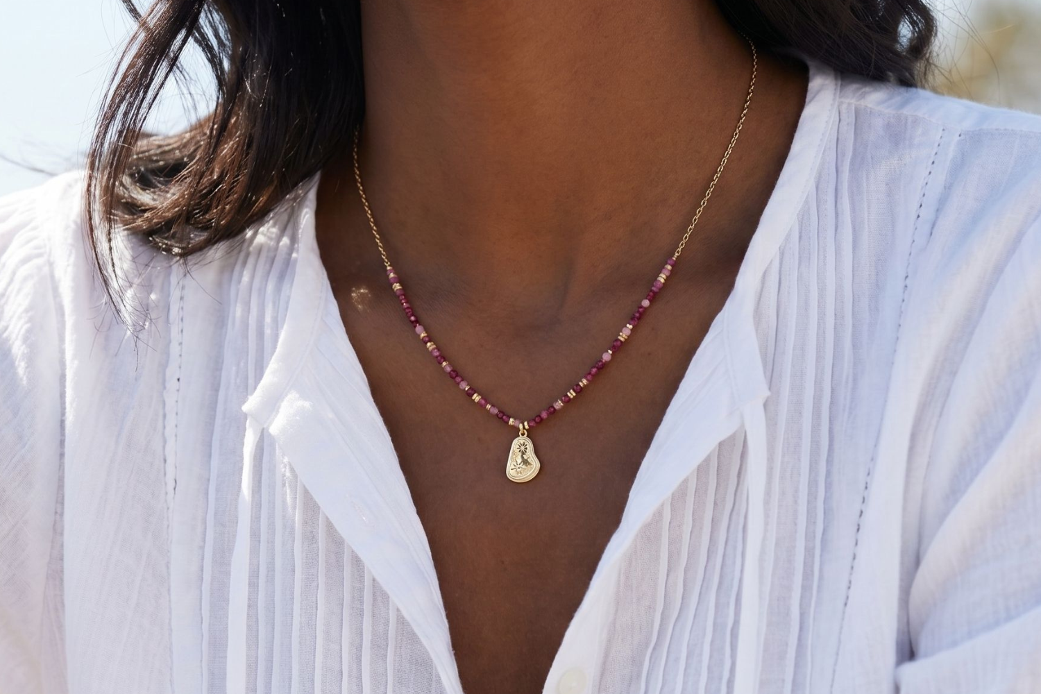 Armino ruby mix gold beaded pendant necklace styled layered with gold chains, a colourful gemstone necklace with star charm