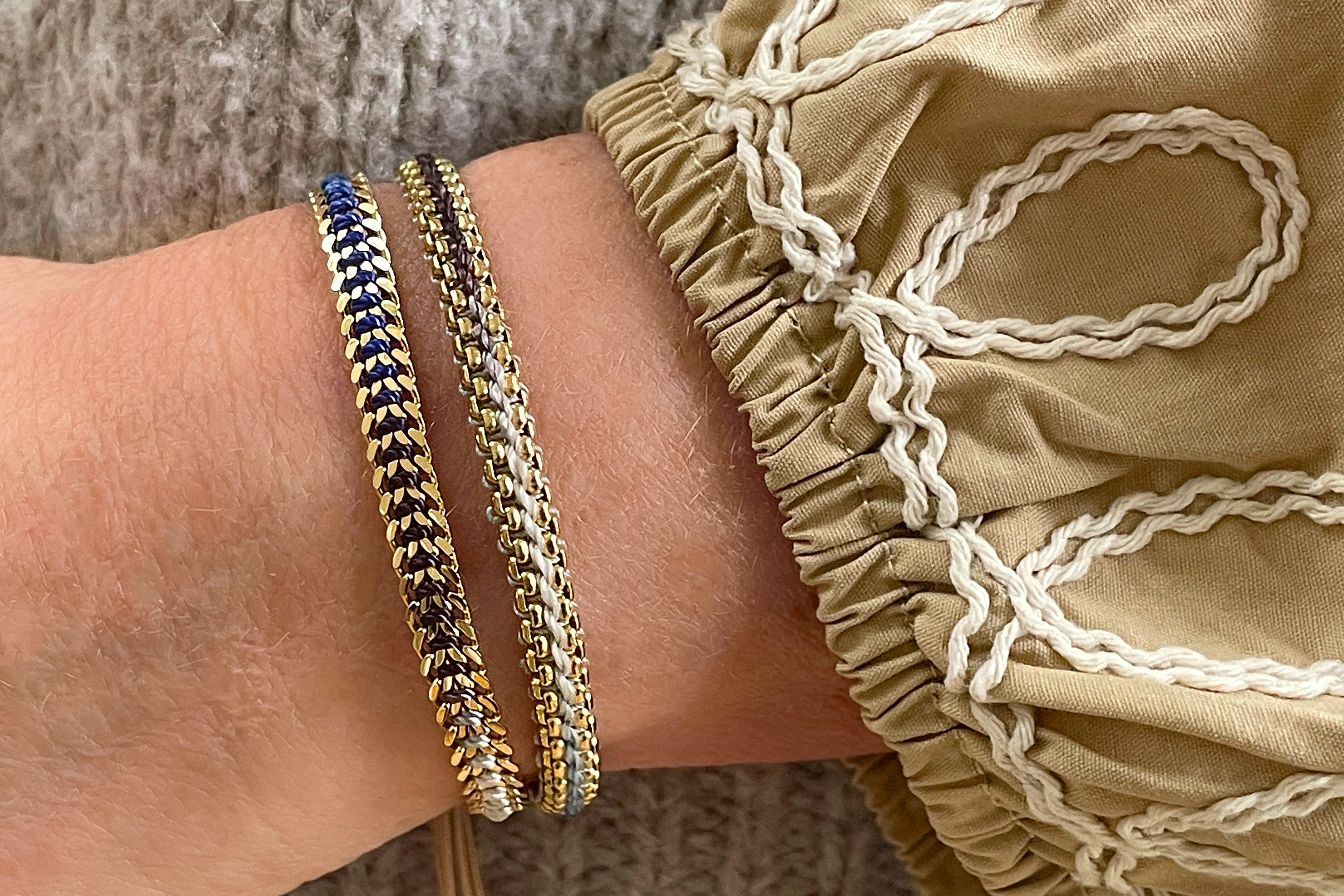 Athena Denim Gold Braided Bracelet styled on the wrist, featuring a blue ombre thread and gold curb chain accents, ideal for summer adventures and effortless elegance.