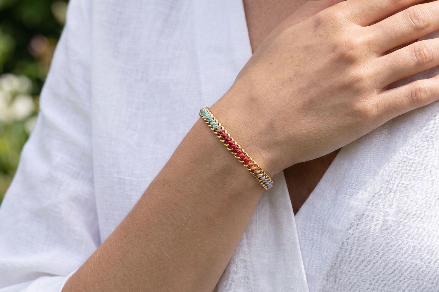 Athena Moroccan Spice Gold Braided Bracelet styled on the wrist, showcasing colourful woven thread detailing and waterproof gold PVD accents for vibrant boho styling.