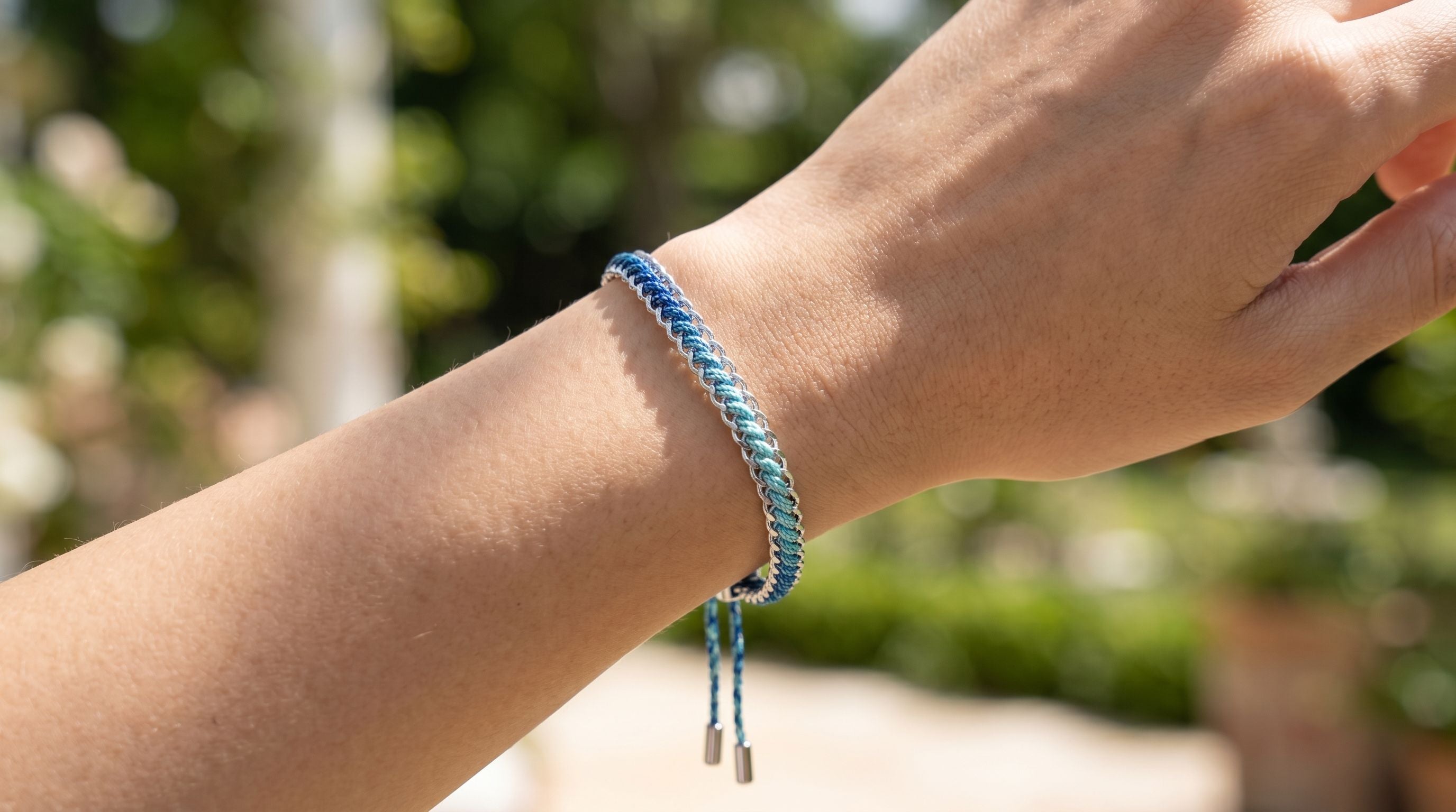 Athena sky blue woven bracelet styled on the wrist, a cool-toned silver friendship bracelet perfect for stacking and everyday wear.