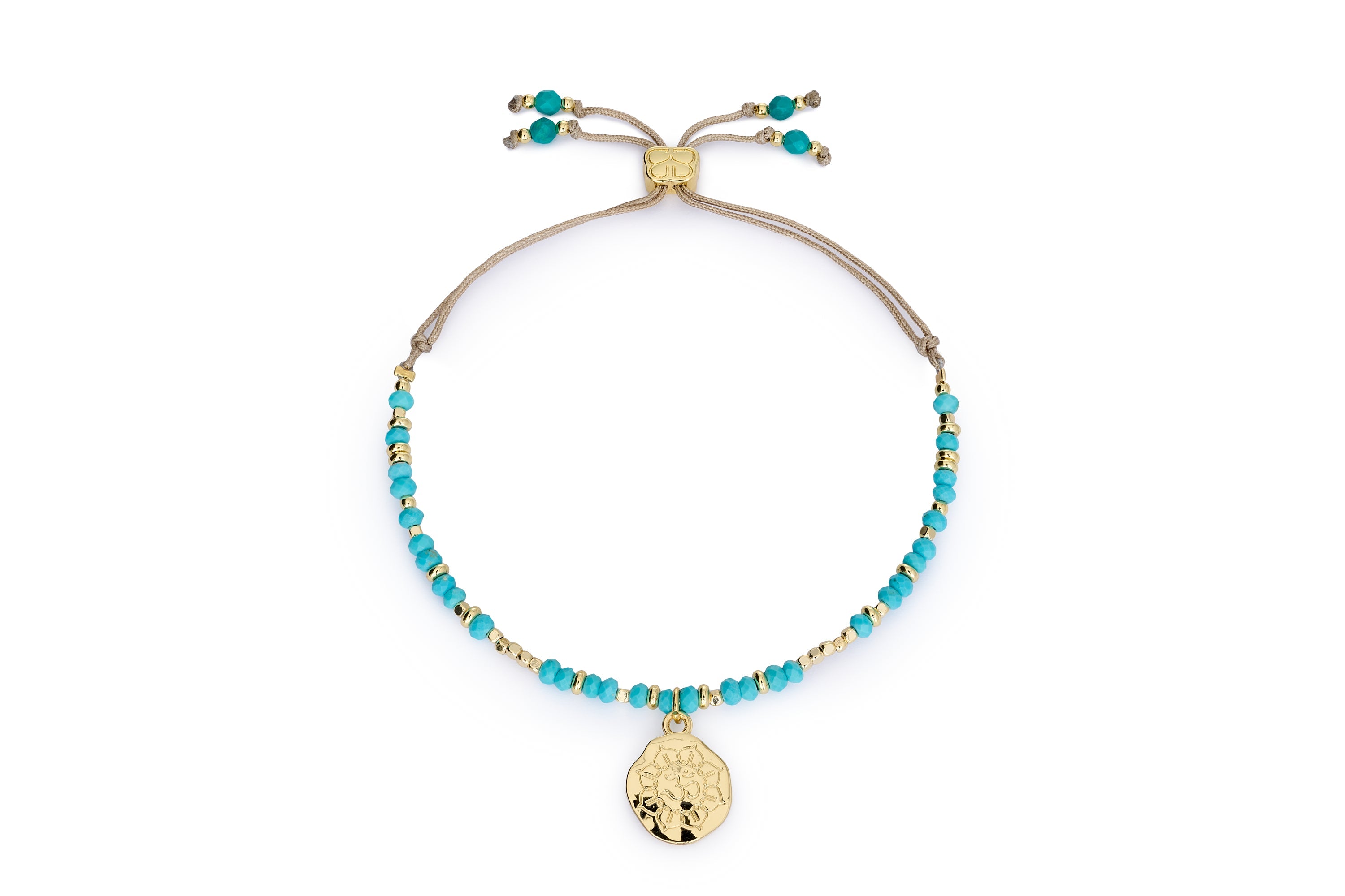 Turquoise howlite Om charm bracelet with gold accents and Boho Betty slider on white background