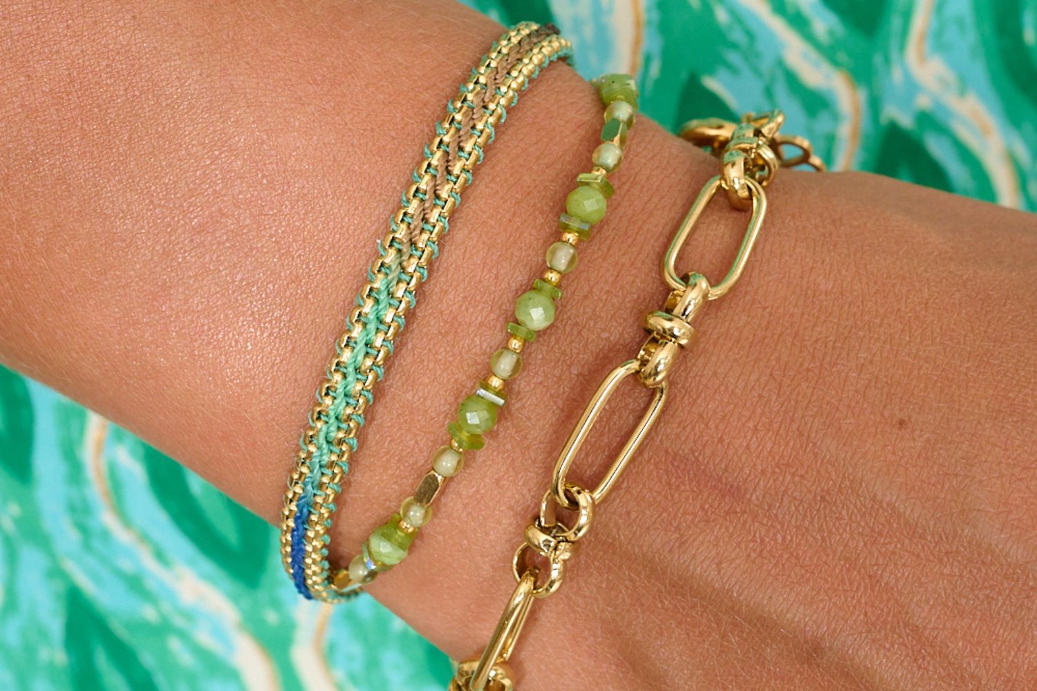 Bloom green and taupe ombre braided bracelet perfectly layered with the Aya green jade gemstone bracelet and Eleni link gold bracelet. layered with a summery aqua dress, perfect summer styling and new additions to the Boho Betty waterproof range.