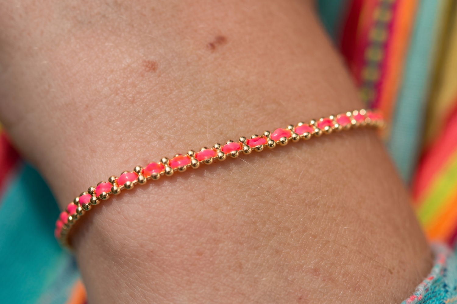 Braid Ibiza Electric Gold Woven Friendship Bracelet styled on the wrist, showcasing colourful Ibiza-inspired woven threads and warm 14k gold PVD details.
