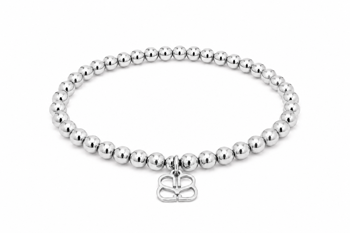 Cleo Silver Bead Stretch Bracelet featuring smooth polished silver-tone beads, a signature BB filigree charm and waterproof White Gold PVD-coated stainless steel.