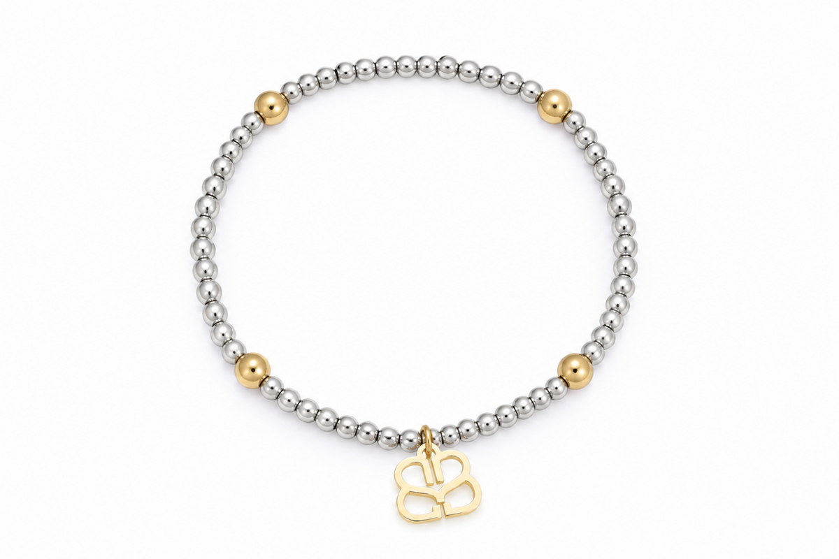 Cora waterproof two-tone gold and silver bead stretch bracelet by Boho Betty – mostly silver beads with gold accents and logo charm, 18cm stretch fit, stackable and waterproof