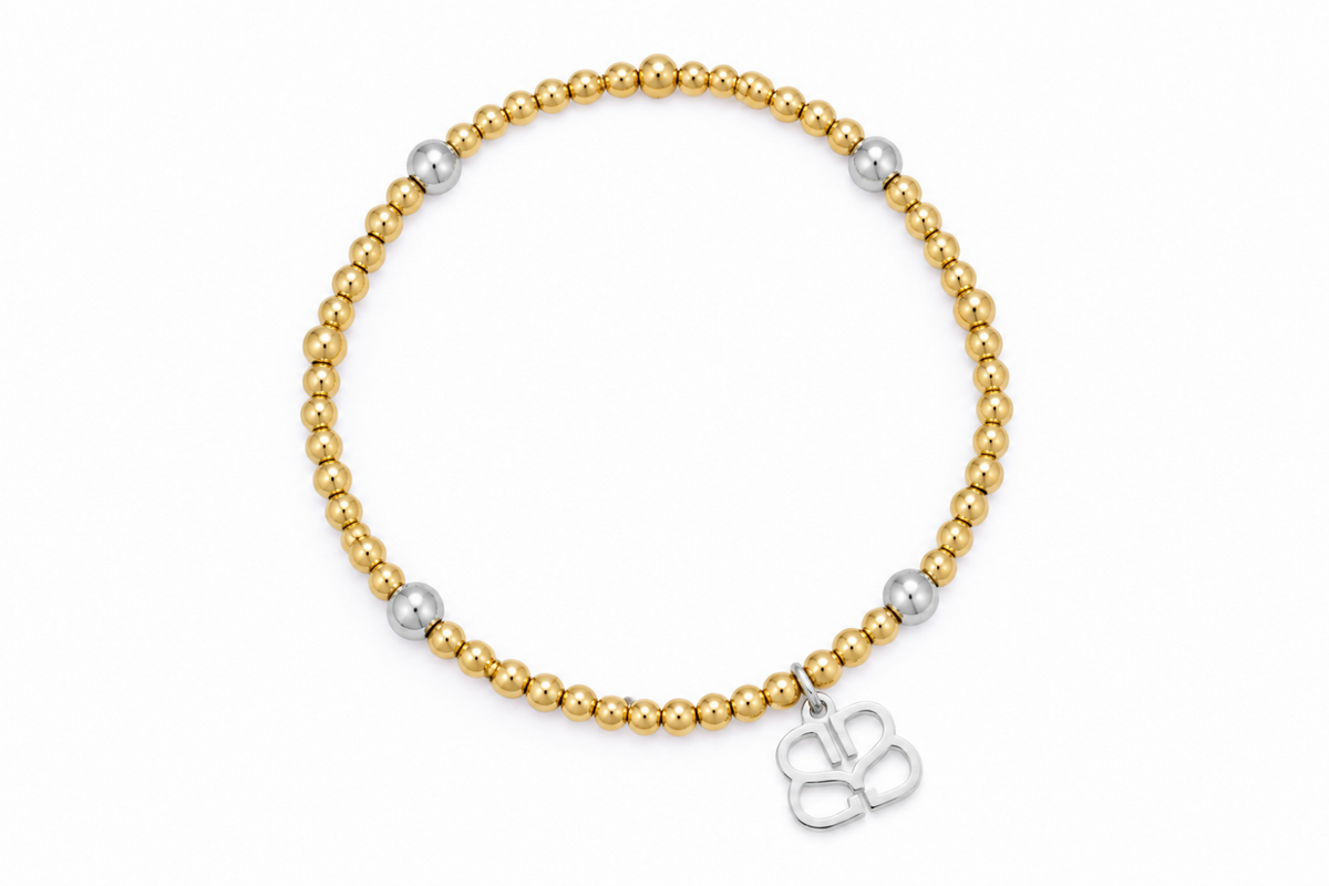 Cora waterproof two-tone silver and gold bead stretch bracelet by Boho Betty – mostly gold beads with silver accents and logo charm, 18cm stretch fit, stackable and waterproof
