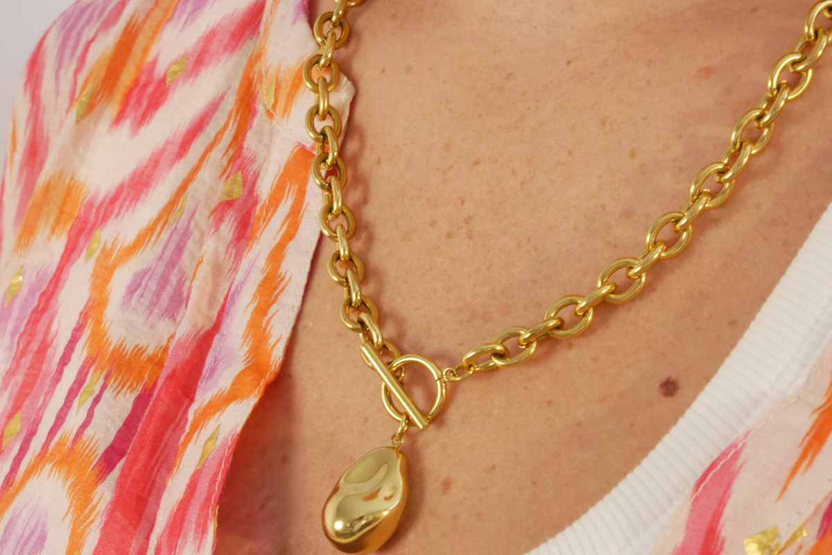 Bindu Gold Nugget Pendant T-Bar Chain Necklace worn as a statement piece, featuring a chunky gold chain, organic nugget pendant and front T-bar fastening.