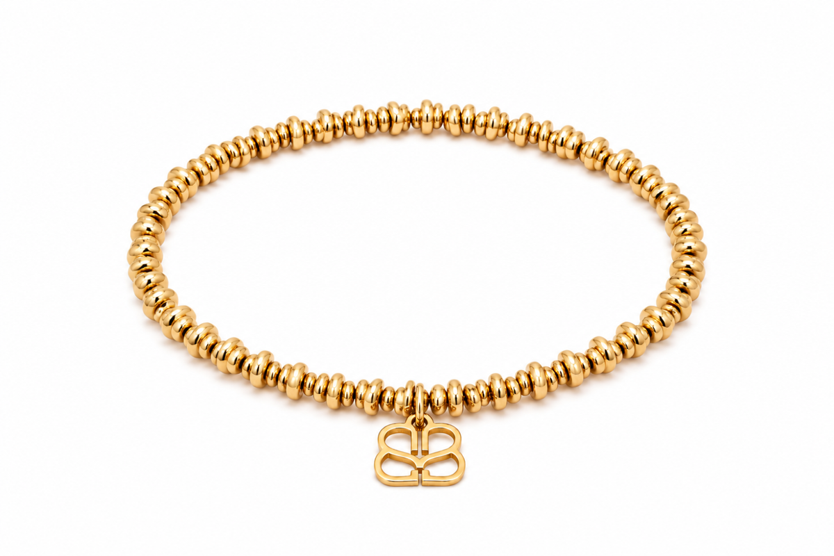 Enso Gold Waterproof Stretch Bead Bracelet featuring polished round and rondelle beads with a signature Boho Betty filigree charm in waterproof 14k Gold PVD stainless steel.