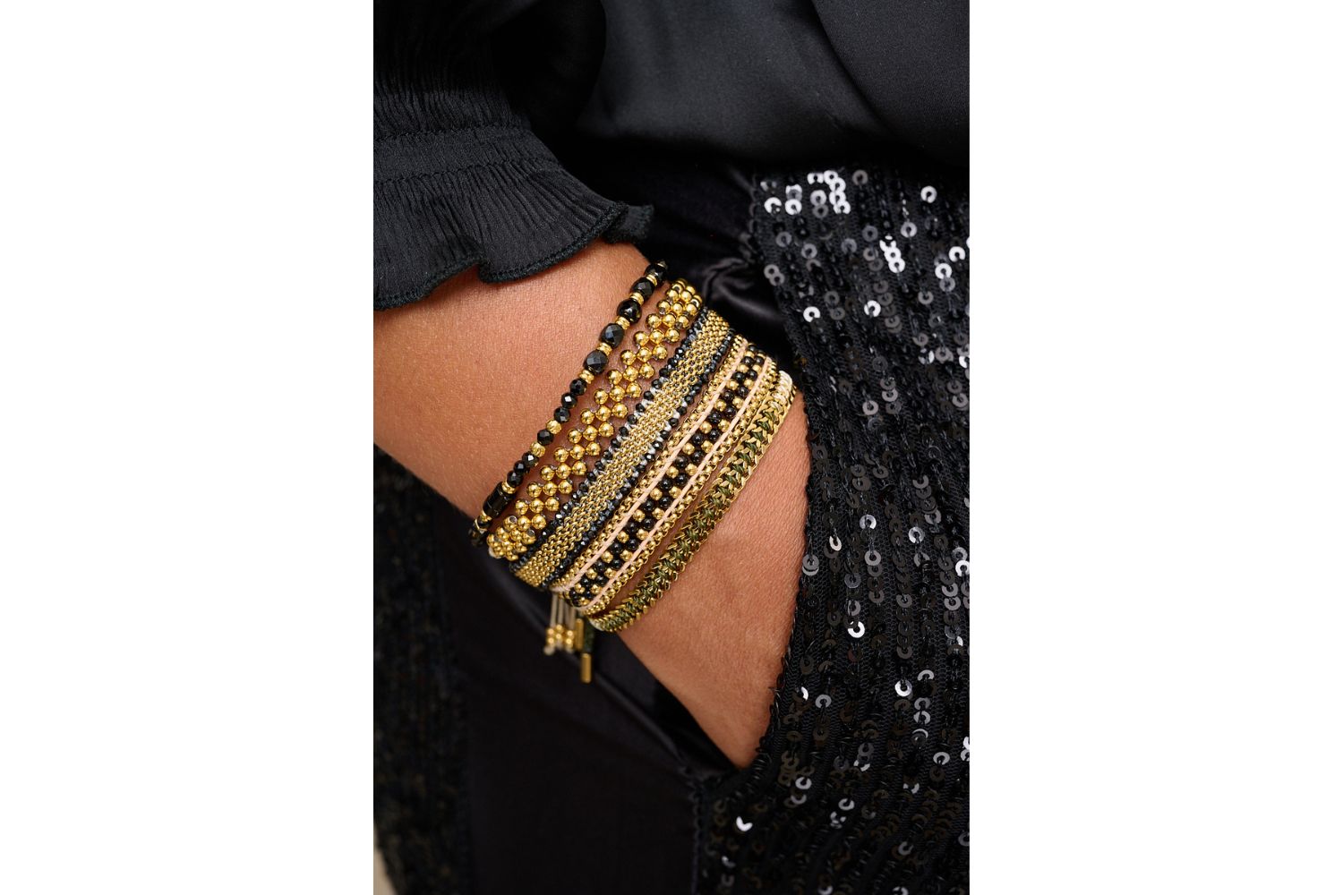 Freya Black Spinel & Gold Chain Bracelet styled on wrist with gold chain and glossy black spinel beads.