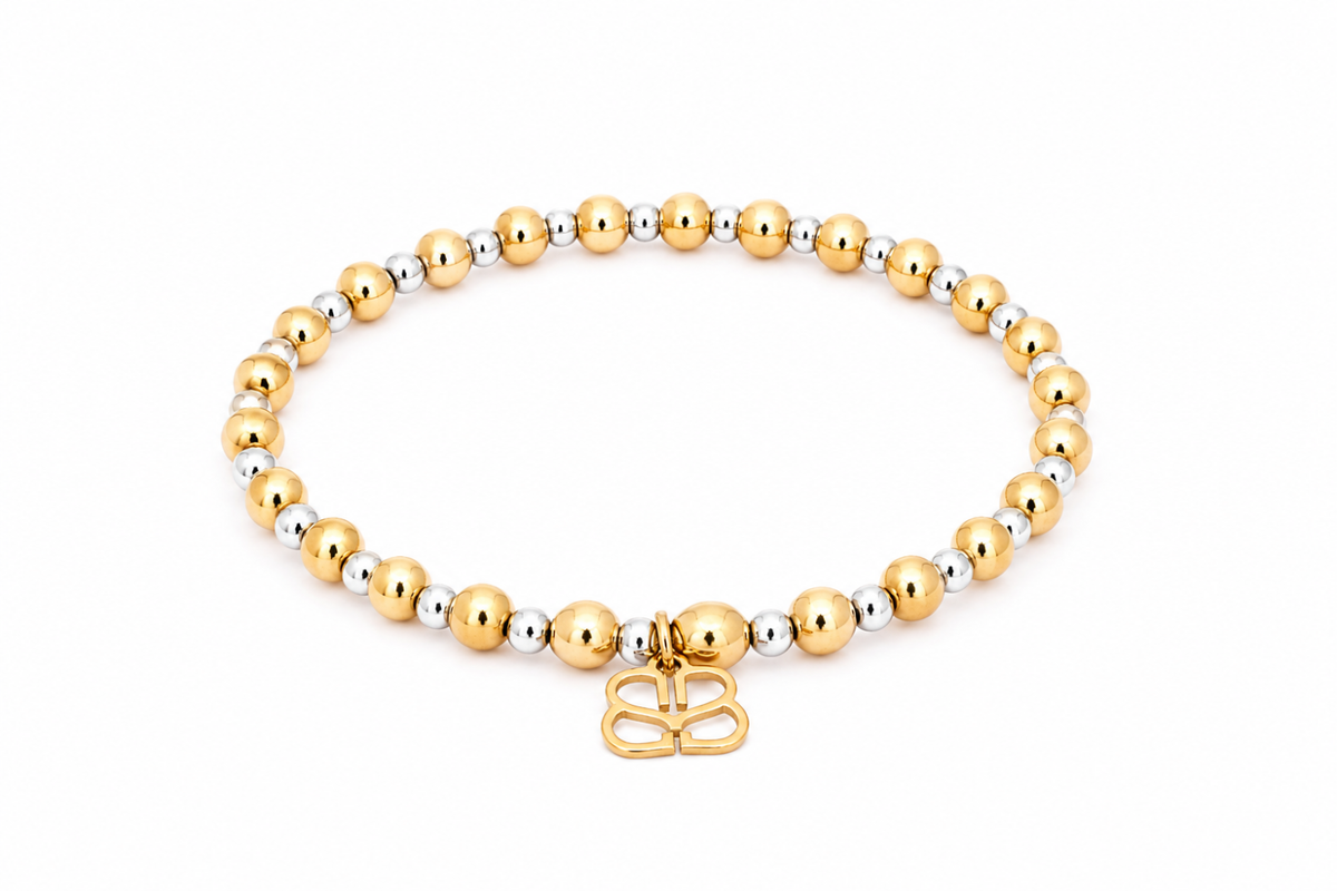 Gemma Gold Mixed Metal Bead Bracelet featuring polished gold-tone beads with silver accents, a signature gold BB filigree charm and waterproof Gold and White Gold PVD-coated stainless steel.