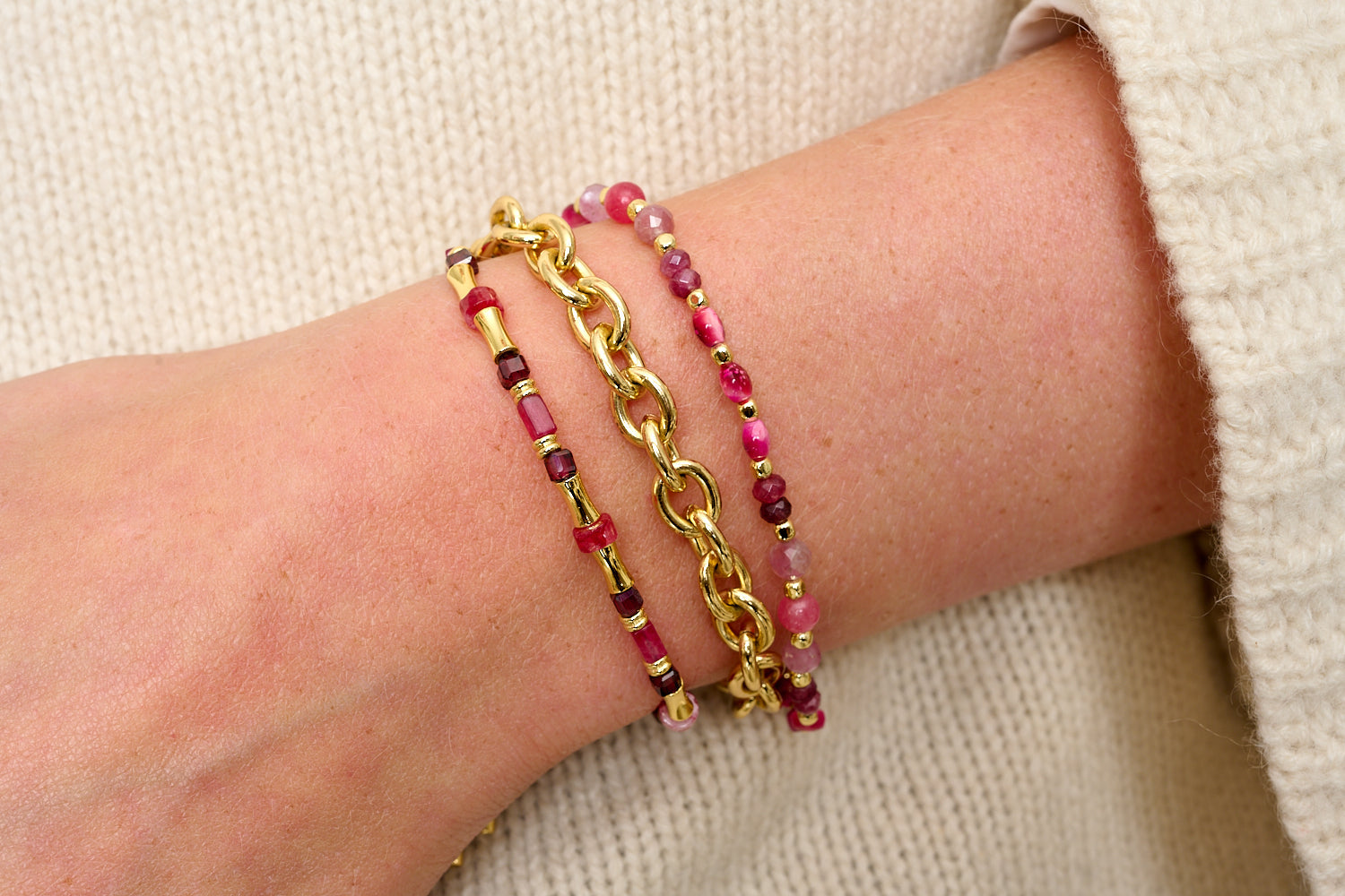 Granito bracelet trio styled for warm, boho-luxe glow, deep garnet, pink tourmaline and bold gold chain.