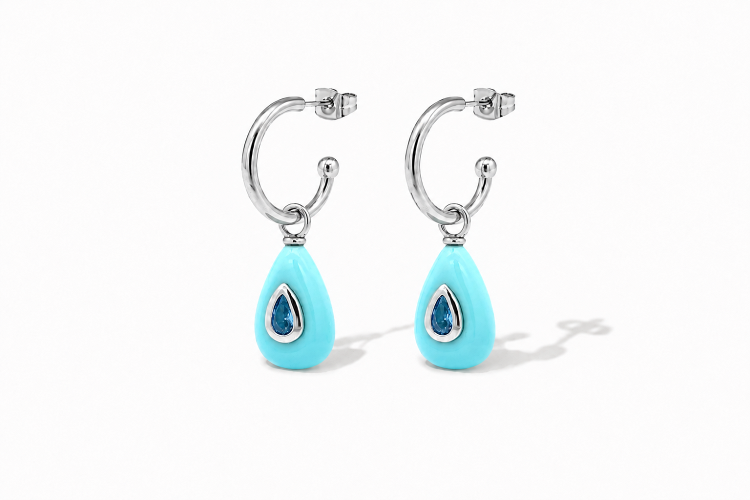 Hana Turquoise Silver Hoop Earrings featuring turquoise-coloured gemstone drops with blue crystal details on waterproof rhodium-plated stainless steel hoops.
