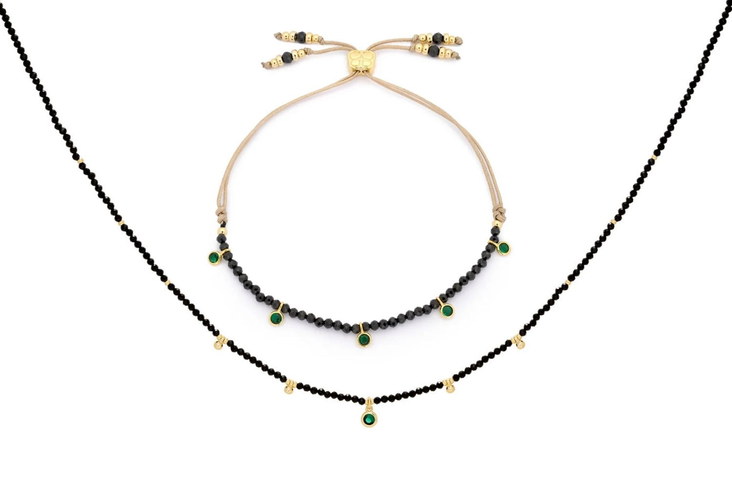 Holly Black Spinel Necklace and Bracelet Set with faceted black spinel beads, emerald-green CZ charms, and 12k gold-plated accents.