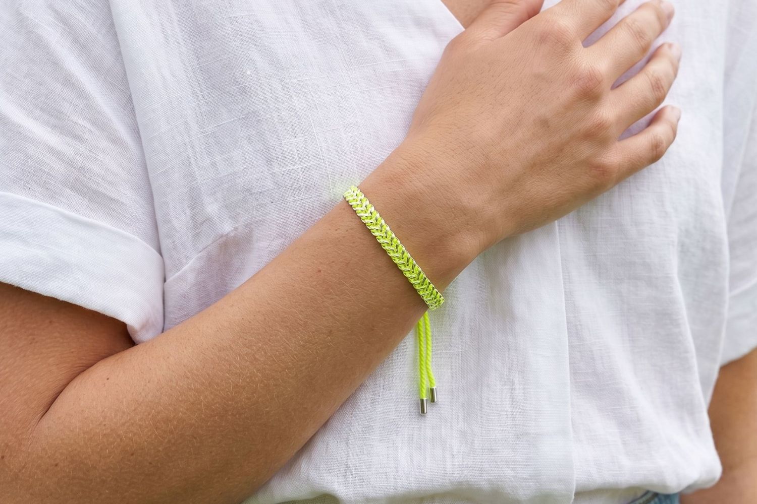 Iztac Silver & Neon Yellow Woven Bracelet styled on the wrist with neon yellow woven detailing and cool silver accents for bold boho stacking.