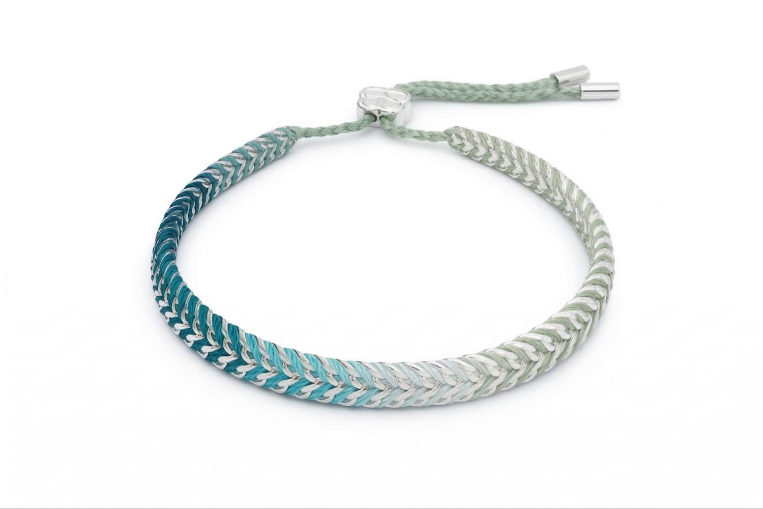 Iztac SKY Silver & Blue Ombre Braided Bracelet worn with a soft knit, showcasing the cool blue ombré weave and sleek silver chain detailing.