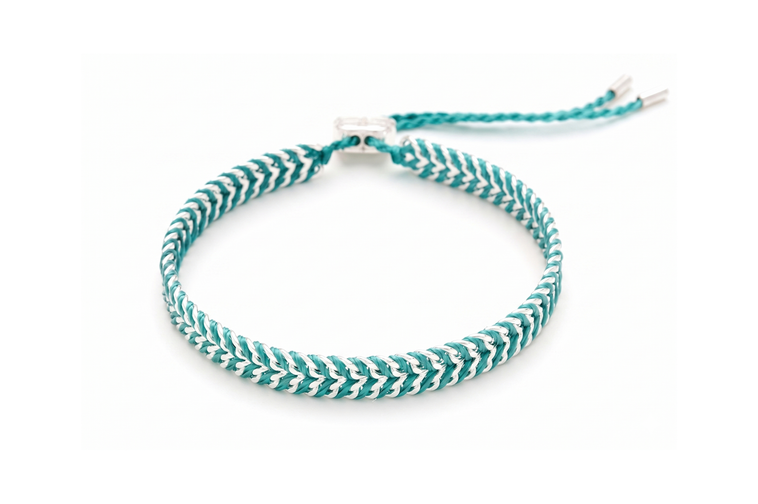 Iztac Teal Silver Woven Bracelet featuring vibrant teal braided thread woven through a polished silver chain with an adjustable slider fastening.