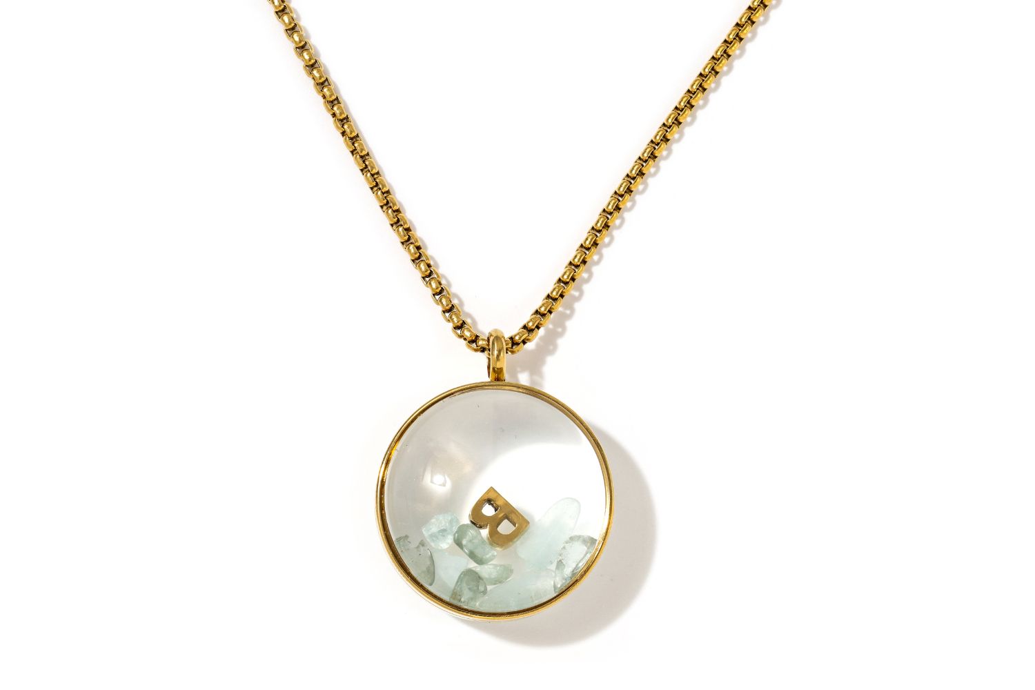 Leilani Personalised Gold Locket Necklace featuring Aquamarine chips and an engraved initial charm inside a glass fillable pendant on a gold chain.