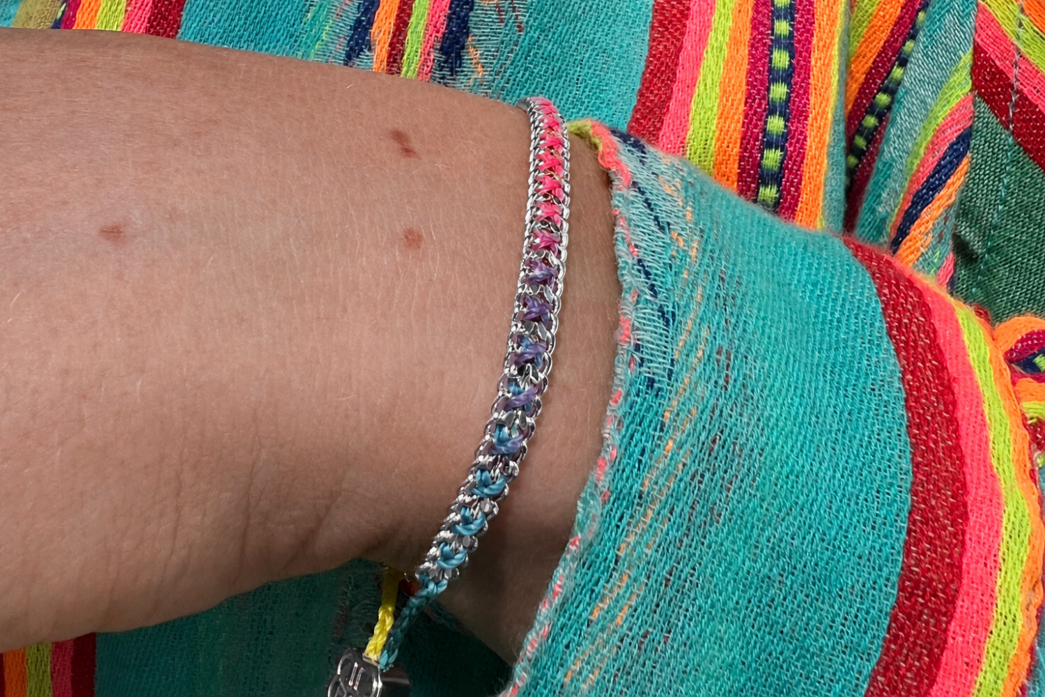 Lilia Havana Brights Silver Braided Bracelet styled on the wrist, showcasing colourful woven threads and white gold PVD details for effortless boho layering.