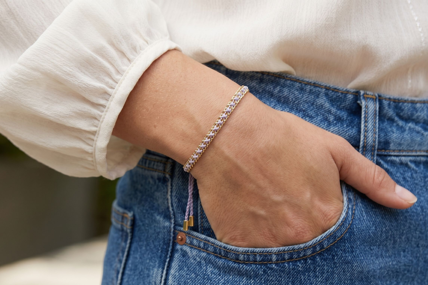 Lilia Lilac Gold Woven Bracelet styled on the wrist, showcasing soft lilac woven detailing and warm gold accents for relaxed boho styling.