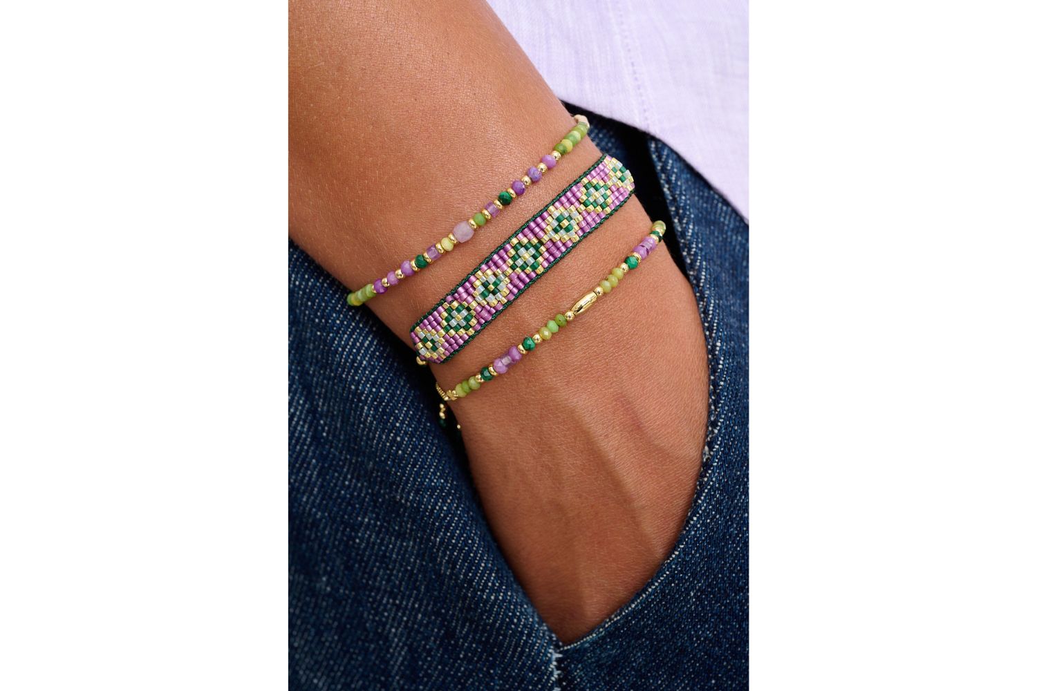 Madeira Purple & Green Gold Bracelet Stack styled on wrist with lilac and green beadwork and gold accents