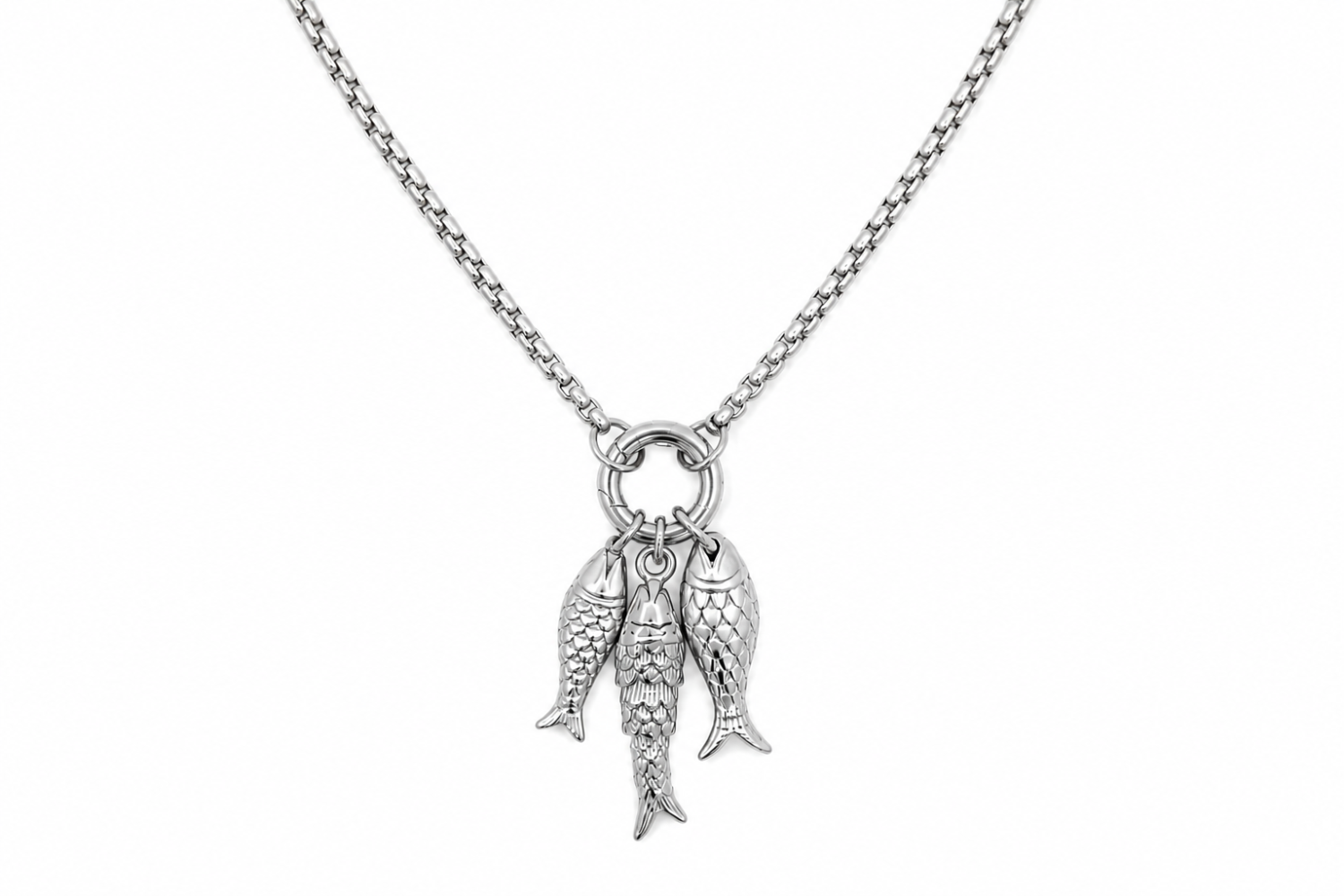 Maris Silver Fish Charm Necklace worn as a statement necklace, featuring three textured silver fish pendants suspended from a chunky round charm carrier.