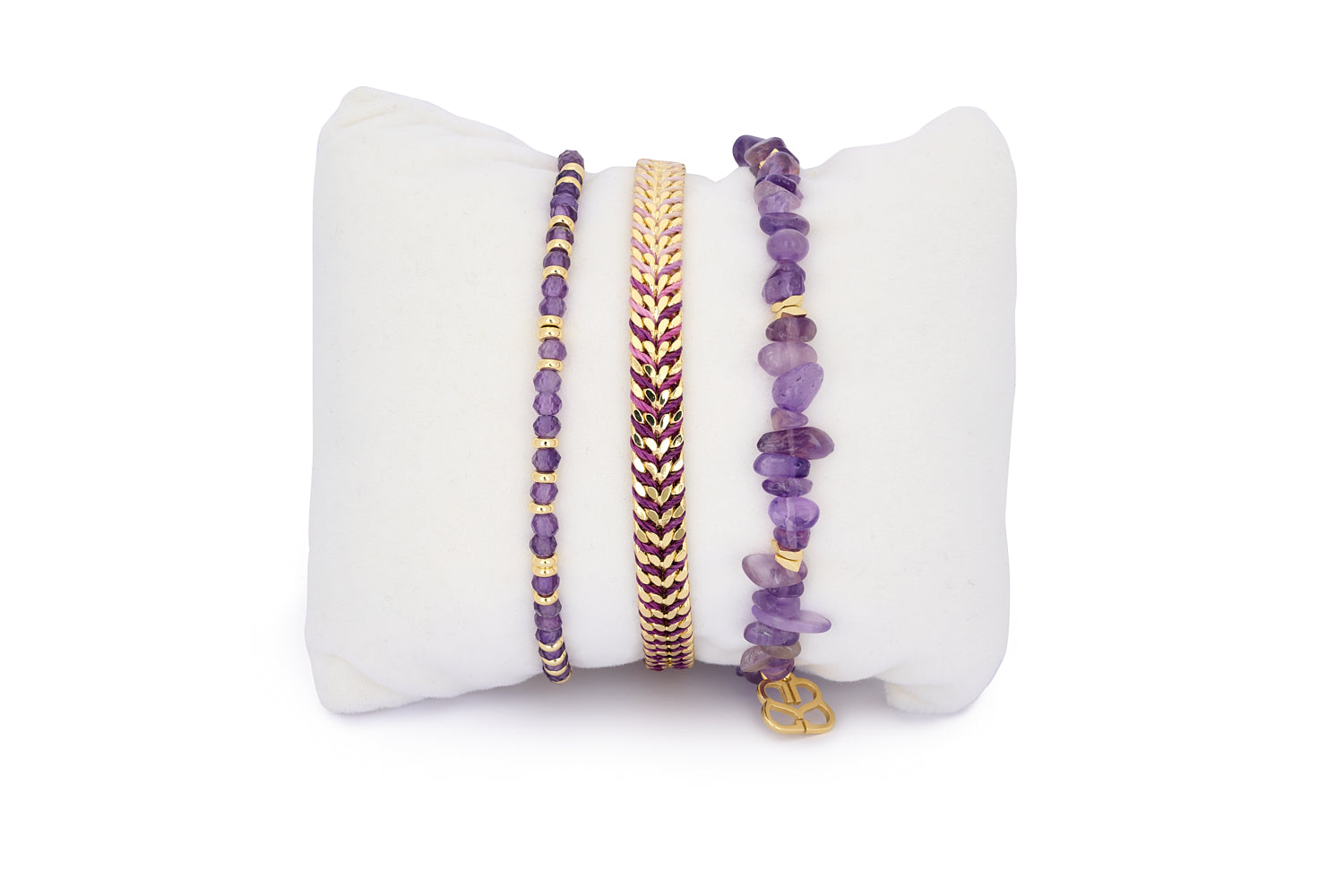 Maupiti Amethyst & Gold Bracelet Stack featuring three amethyst crystal bracelets with gold accents in a mix of braided, beaded, and stretch styles.