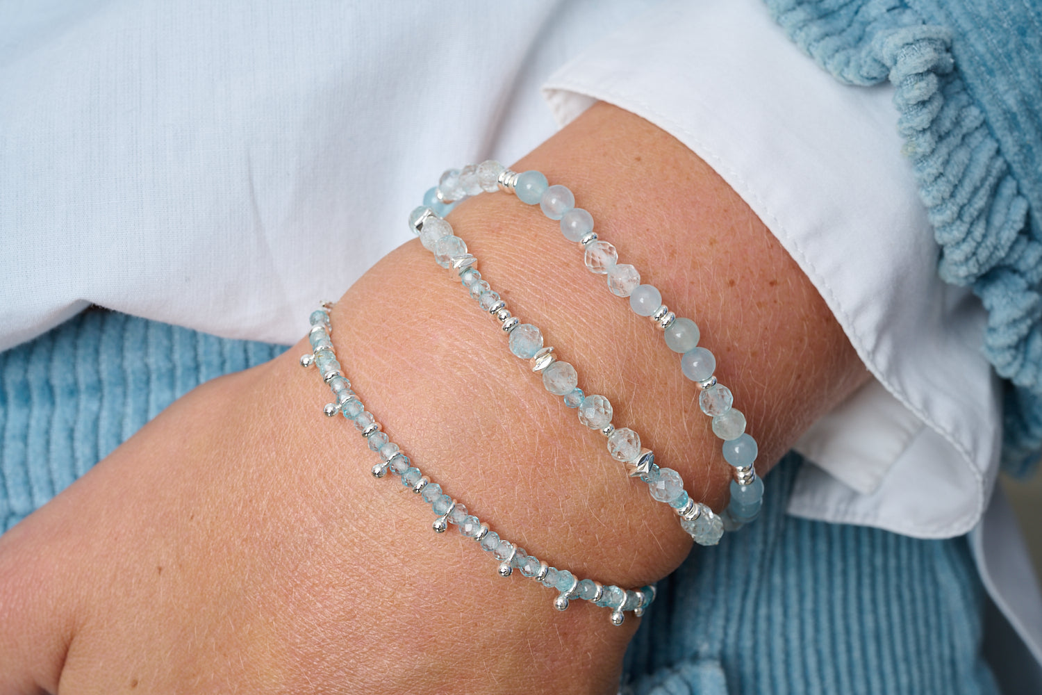 Moala Blue Topaz & Silver Bracelet Stack styled on wrist with layered Boho Betty silver and blue gemstone bracelets