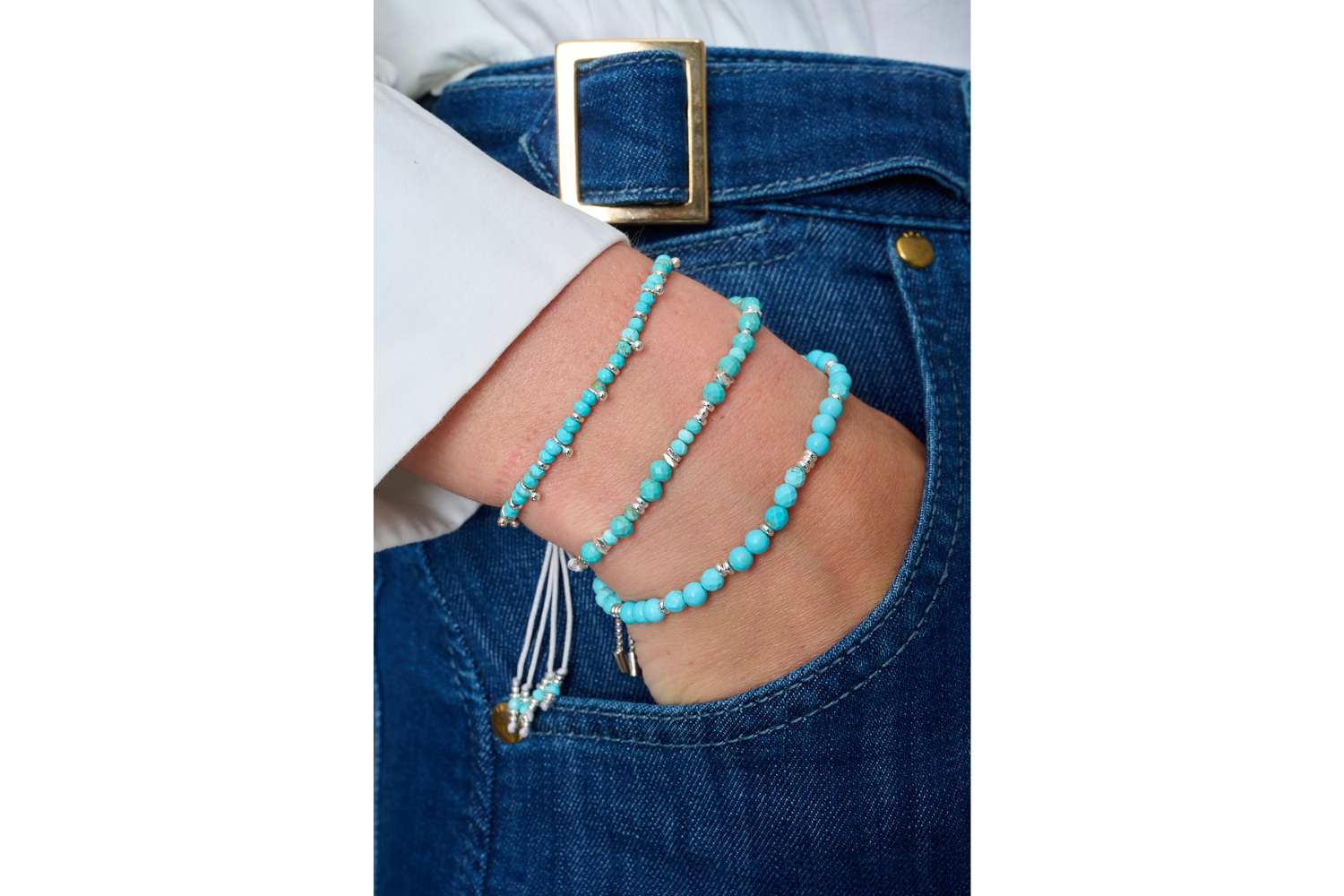 Moala Turquoise Silver Bracelet Stack styled on the wrist, showcasing bright turquoise howlite beads and silver accents for a relaxed bohemian look.