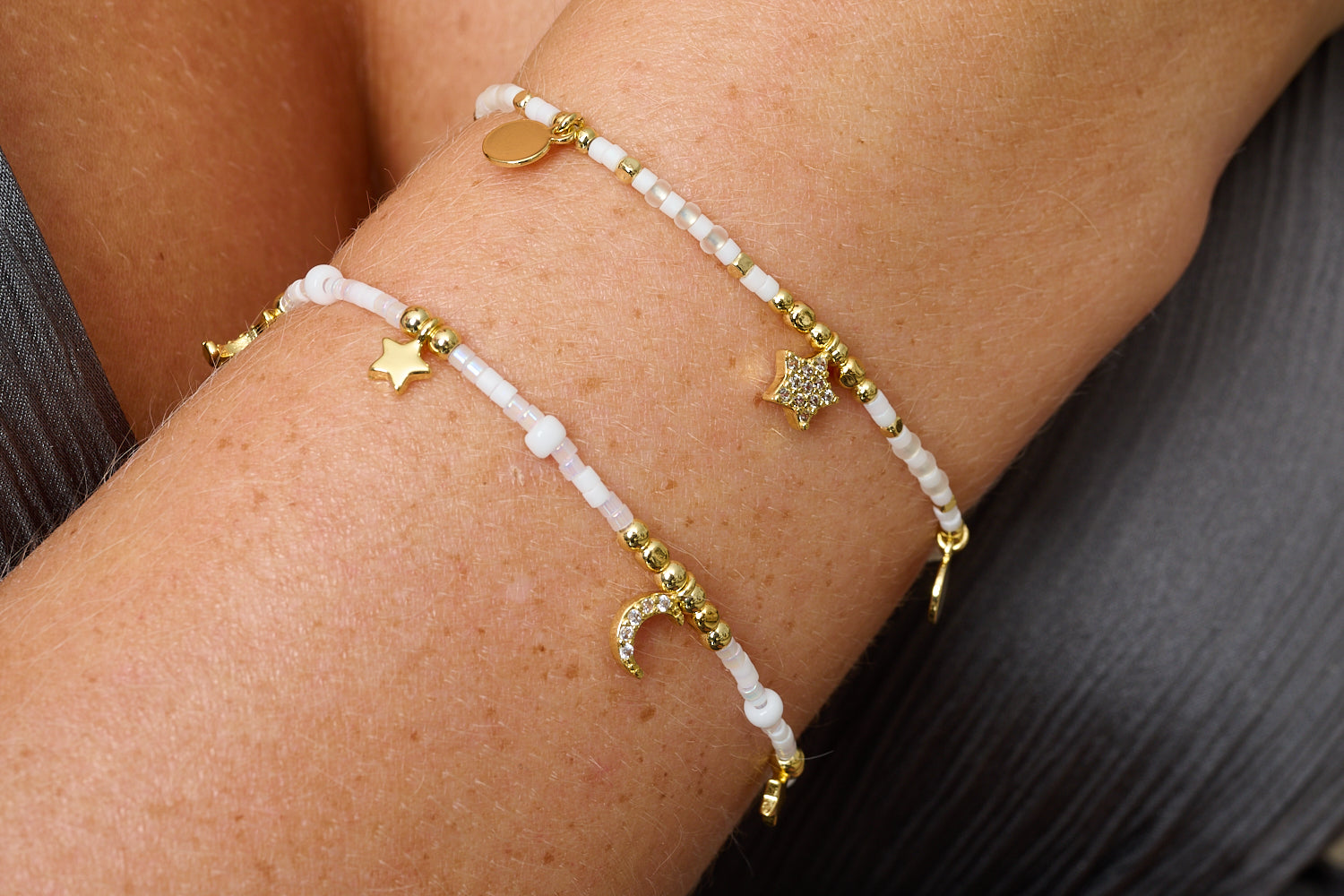 Mondesi White & Gold Stacking Bracelets, ivory Miyuki beads with gold moon and star charms in an adjustable duo.