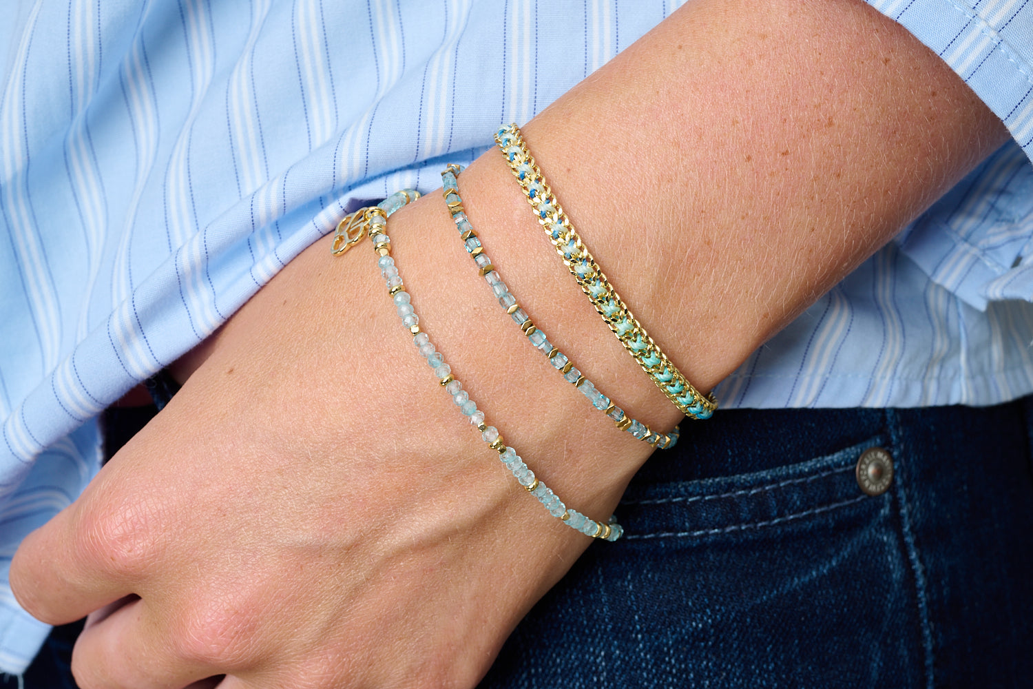 Montosa bracelet trio styled with denim—ocean blue topaz and warm gold for a cool, serene day-to-night glow.