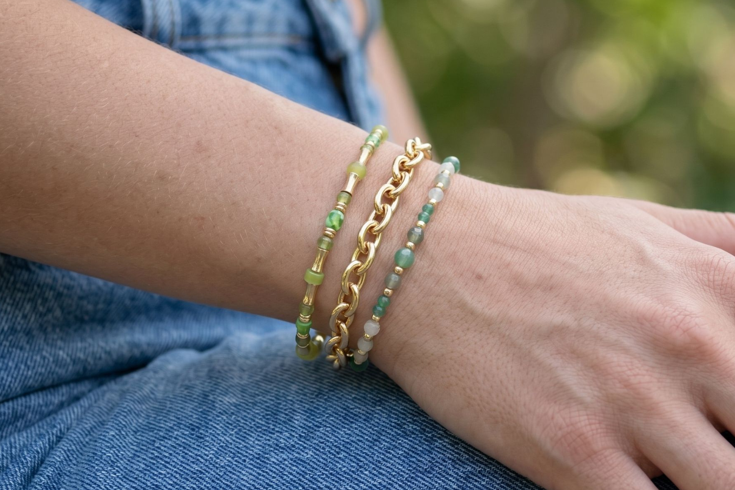 Talofofo Green and Gold Bracelet Stack styled on the wrist, showcasing layered green gemstone beads, chunky gold chain textures and relaxed boho styling.