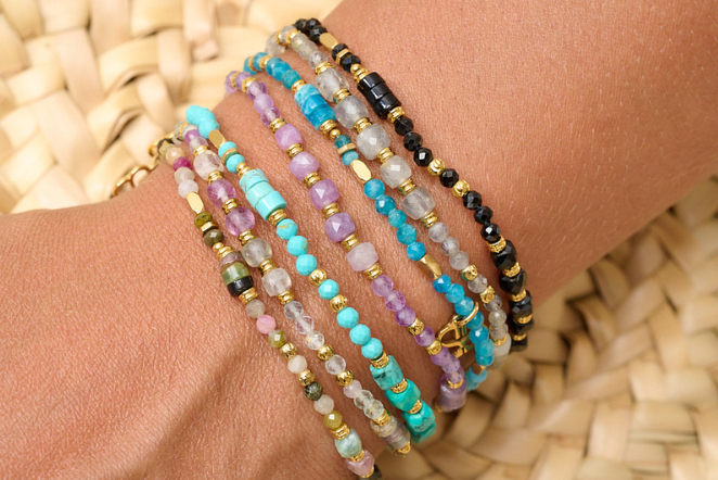 Yasmin Rainbow Fluorite Bracelet styled with layered gold and gemstone bracelets for a colourful, boho-inspired look.