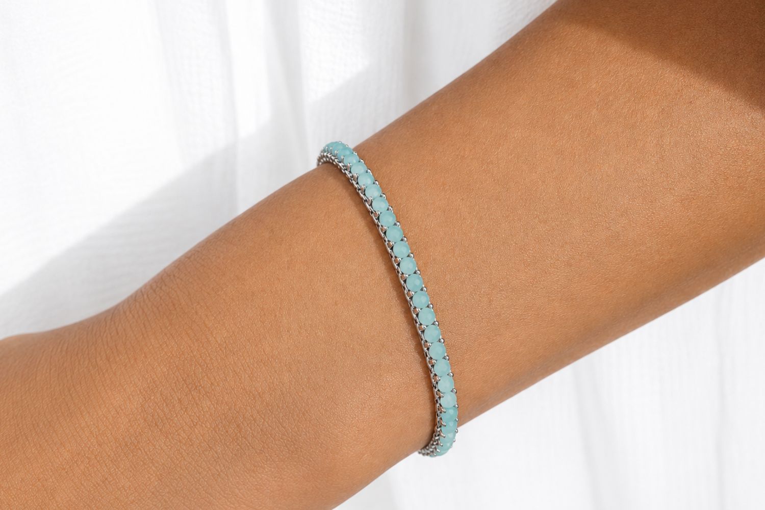 Zena Amazonite silver beaded bracelet styled on the wrist, showing soft sea-green tones and layered silver jewellery.