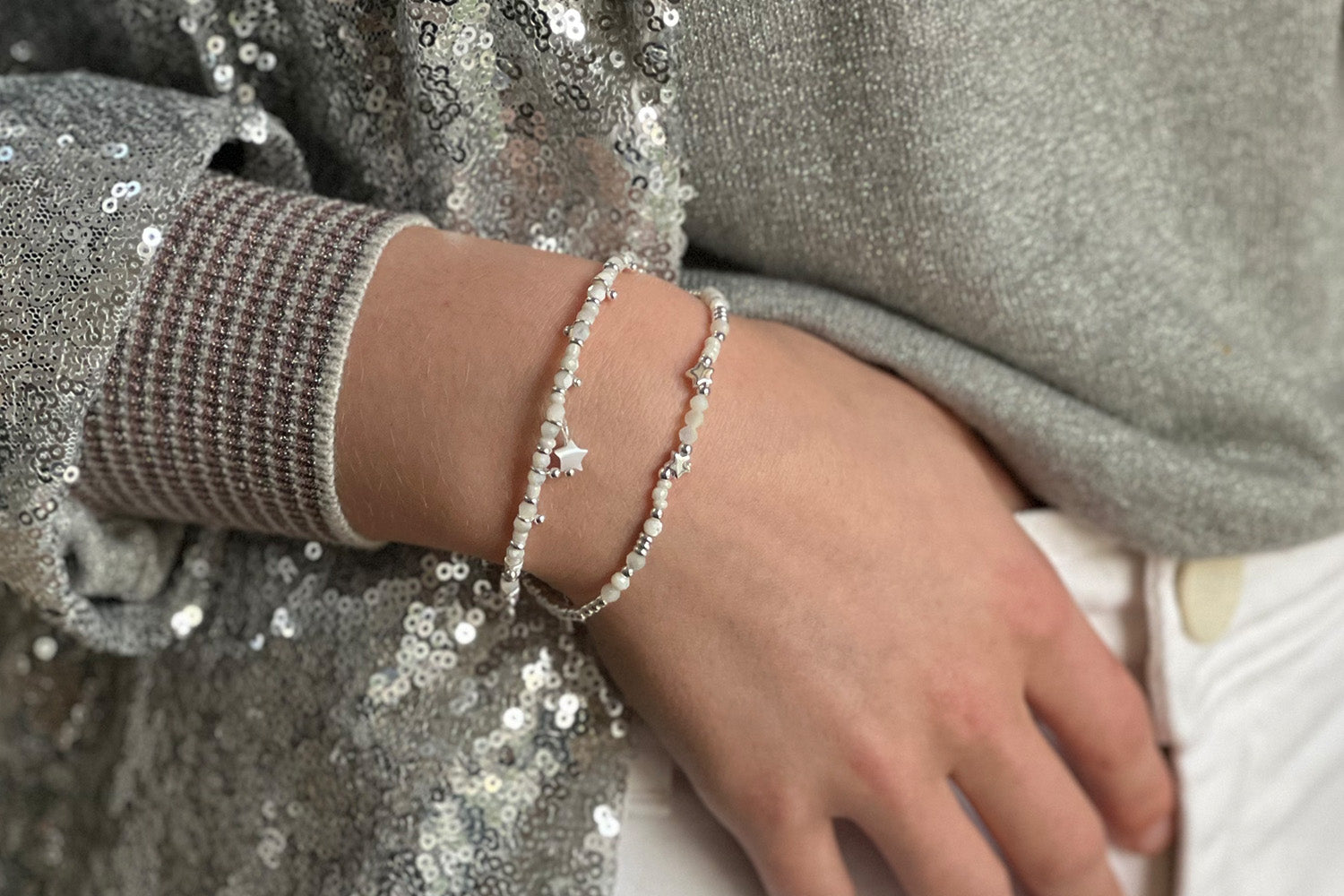 Menkib 2 Layer Bracelet Stack styled on the wrist, showcasing two coordinated bracelets with moonstone, pearls, and star-inspired silver accents, perfect for layering.