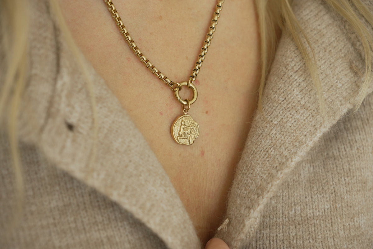 Zaya Aquarius Gold Zodiac Charm by Boho Betty – a waterproof gold Aquarius coin charm, styled on a gold chain necklace