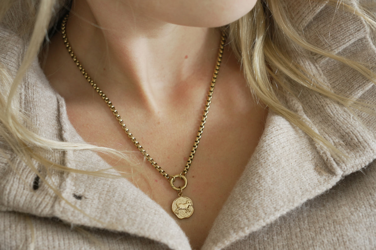 Zaya Aries Gold Zodiac Charm by Boho Betty – a waterproof gold Aries coin charm, styled on a gold chain necklace