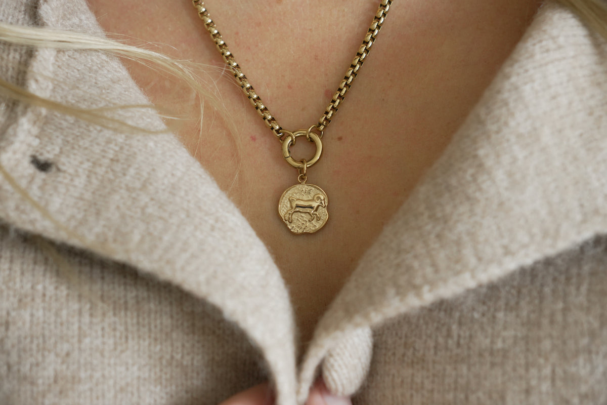 Zaya Aries Gold Zodiac Charm by Boho Betty – a waterproof gold Aries coin pendant worn on a gold chain necklace